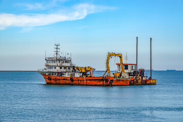 Fishing boat arriving in the harbor to land the lobsters.