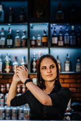 Portrait of young attractive woman bartender Making Cocktail Using Shaker in bar