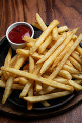 portion of french fries potato snack on wood table background
