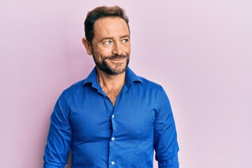Fototapeta premium Middle age man wearing casual clothes smiling looking to the side and staring away thinking.