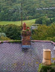 Fototapeta na wymiar rooftop chimney pots seen from eye level on the medieval Conwy town wall walk