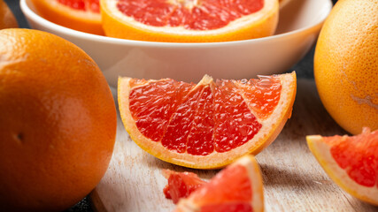 Juicy Grapefruit slices on white wooden board. Healthy food