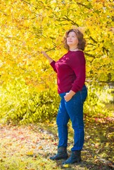 Plus size European or American mature woman at park, enjoy the life, walks. Life of people xl size, happy nice natural beauty woman. Concept of overweight