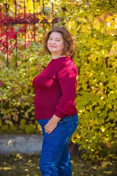 Plus size European or American mature woman at park, enjoy the life, walks. Life of people xl size, happy nice natural beauty woman. Concept of overweight