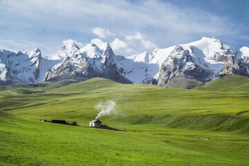 A lonely house in alpine meadows 3200m above sea level and surrounded by snowy mountains. Kok-Kiya...