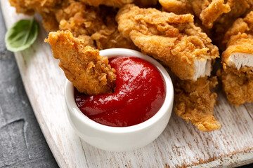 Fried Chicken strips with ketchup on white wooden board. Fast Food