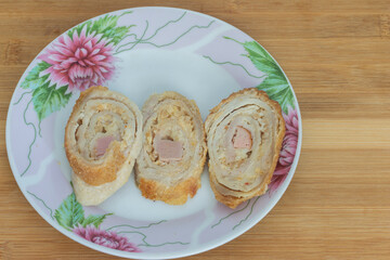 three slices of sliced meatloaf in a plate close-up
