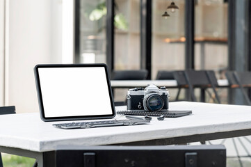 Blank screen tablet and gadget on the table outdoors.