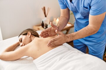 Fototapeta na wymiar Woman smiling happy reciving back massage at beauty center.