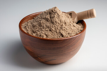 Raw flax seeds flour in a wooden bowl with on white background.
