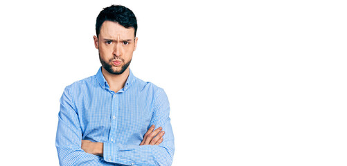 Fototapeta premium Hispanic man with beard with arms crossed gesture puffing cheeks with funny face. mouth inflated with air, catching air.