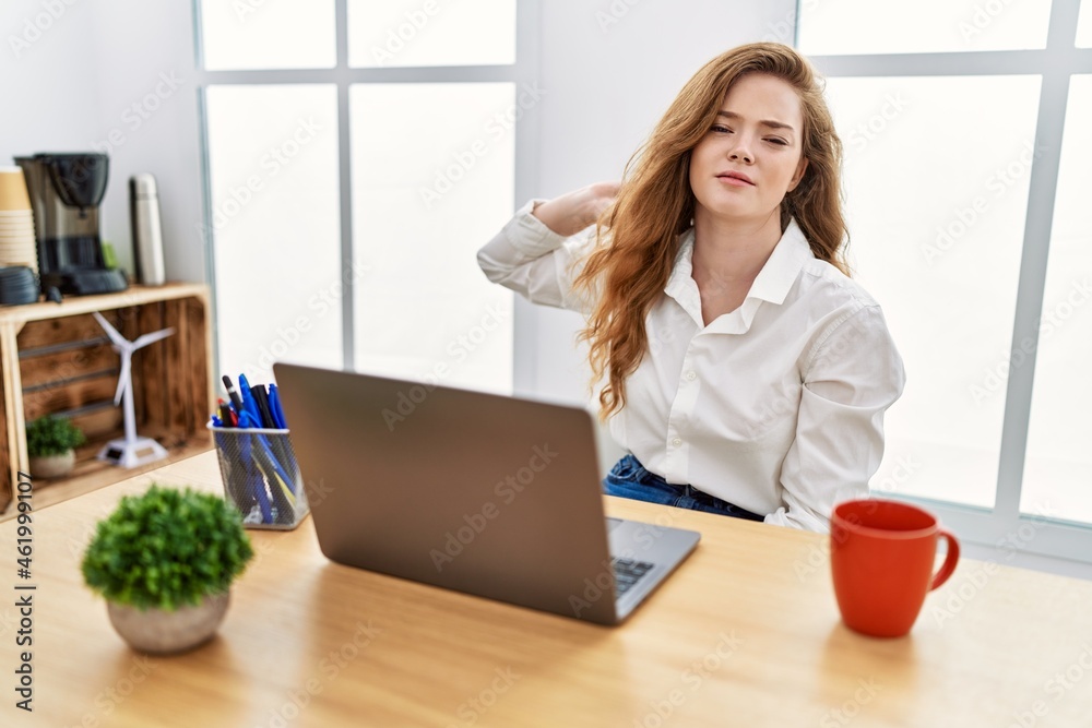 Poster young caucasian woman working at the office using computer laptop suffering of neck ache injury, tou