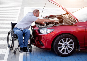 person with a physical disability check engine his car at parking