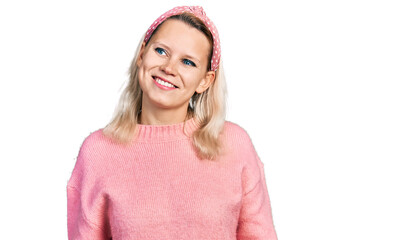 Young caucasian woman wearing casual clothes looking away to side with smile on face, natural expression. laughing confident.