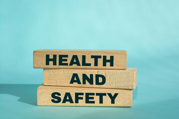 Health and Safety Text on Wooden Blocks on blue Background