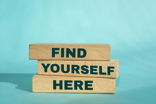 Find Yourself Here Text on Wooden Blocks on blue Background