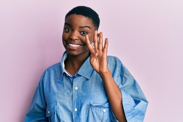 Young african american woman wearing casual clothes showing and pointing up with fingers number four while smiling confident and happy.