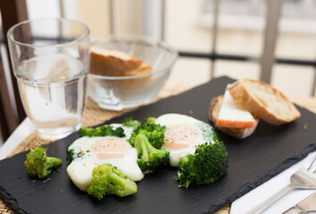 breakfast of crumpled eggs with broccoli