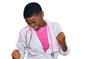 Young african american woman wearing doctor uniform and stethoscope very happy and excited doing...