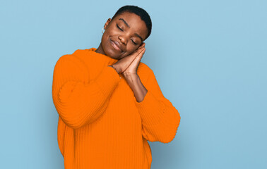 Young african american woman wearing casual clothes sleeping tired dreaming and posing with hands together while smiling with closed eyes.