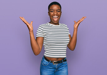 Young african american woman wearing casual clothes celebrating victory with happy smile and winner expression with raised hands