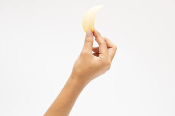 Fototapeta na wymiar Hand holds potato chips. Isolated on a white background.