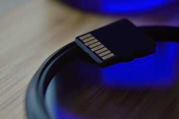 micro sd card for use in photo and video technology. micro sd lies on the lens filter. close-up.