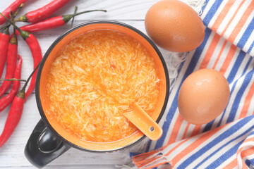 Traditional chinese egg drop soup with chili and egg on table,