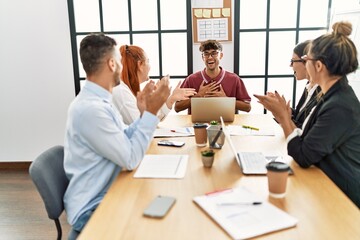 Fototapeta premium Group of business workers smiling and clapping to partner at the office.