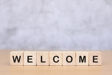 welcome word on wooden cube on wooden table background