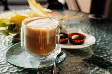 autumn coffee in a transparent cup with sweets