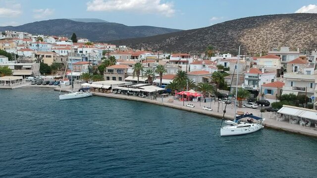 Aerial panoramic photo of picturesque seaside town of Ermioni built in peninsula with forest of Bistis at the end, Argolida, Peloponnese, Greece