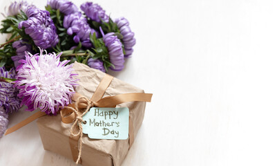 Gift box with a wish for a happy mother's day on a white background, copy space.