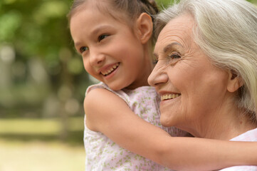 Happy grandmother and granddaughter in the park