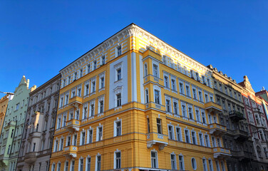 Fototapeta na wymiar Bright yellow corner building