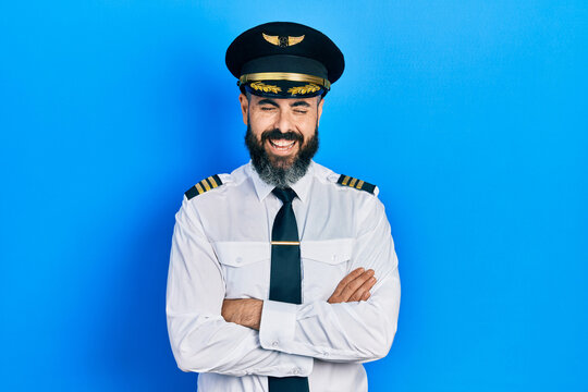 Young Hispanic Man Wearing Airplane Pilot Uniform With Arms Crossed Gesture Smiling And Laughing Hard Out Loud Because Funny Crazy Joke.