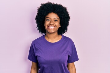 Fototapeta na wymiar Young african american woman wearing casual clothes looking positive and happy standing and smiling with a confident smile showing teeth