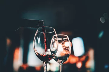 Foto op Aluminium waiter pouring red wine into a glass in cafe or bar © pavel siamionov