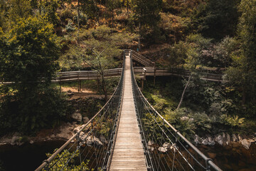 Fototapeta na wymiar Wood suspended pedestrian bridge at Passadiços do Paiva in Arouca Geopark