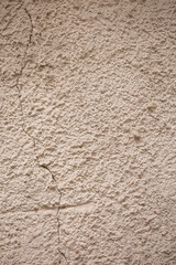 beige textured wall made of cement and sand. natural background for design