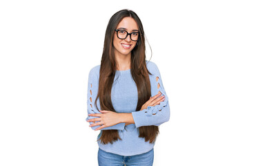Young hispanic girl wearing casual clothes and glasses happy face smiling with crossed arms looking...