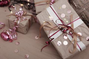 Close up of Christmas gifts wrapped in craft paper.