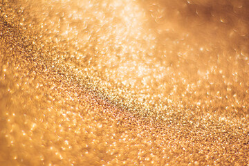 Golden background with bokeh and glitter, valentine's day, christmas and new year background, selective focus