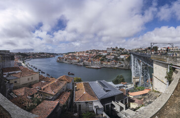 Scenic view of a river and Luis I Bridge in Porto, Portugal on a cloudy sky background