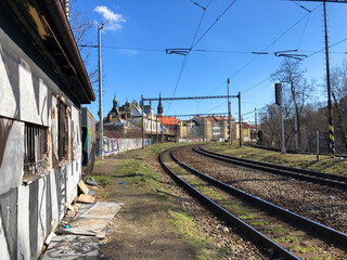Fototapeta na wymiar Train tracks passing by the ruins of an old station