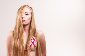 Woman chest in bra, pink cancer ribbon