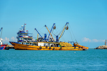 Fototapeta premium The returning fishing ship enters the harbor.