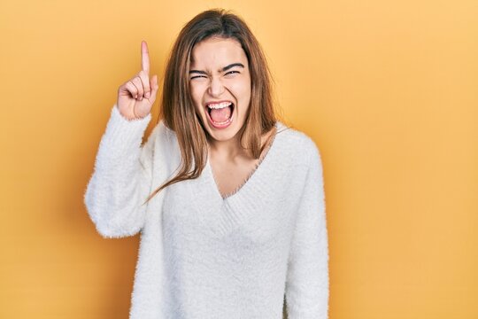 Young caucasian girl wearing casual clothes pointing finger up with successful idea. exited and happy. number one.