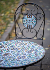 Textured table and chair with beautiful patterns outdoors.