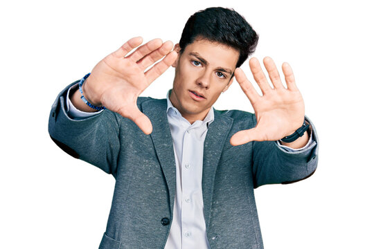 Young hispanic man wearing business clothes doing frame using hands palms and fingers, camera perspective